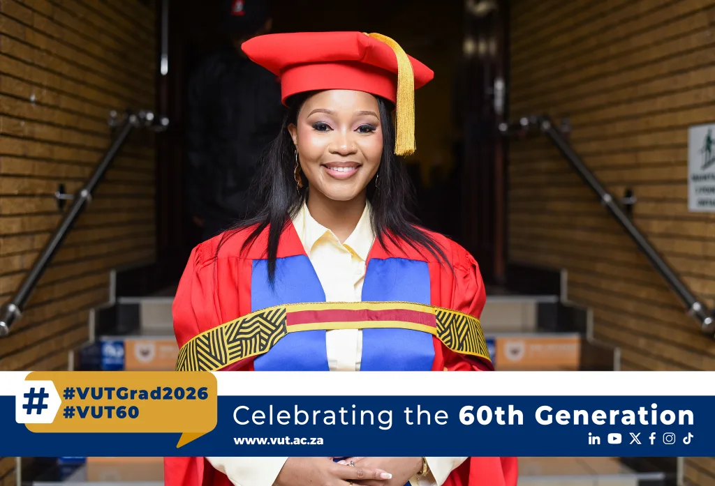 Dr Lerato Simelane – Vaal University of Technology Smiling graduate in a red gown and mortarboard with a gold tassel, standing in a corridor with a decorative sash and a colorful banner at the bottom that reads #VUTGrad2026 and Celebrating the 60th Generation of VUT.