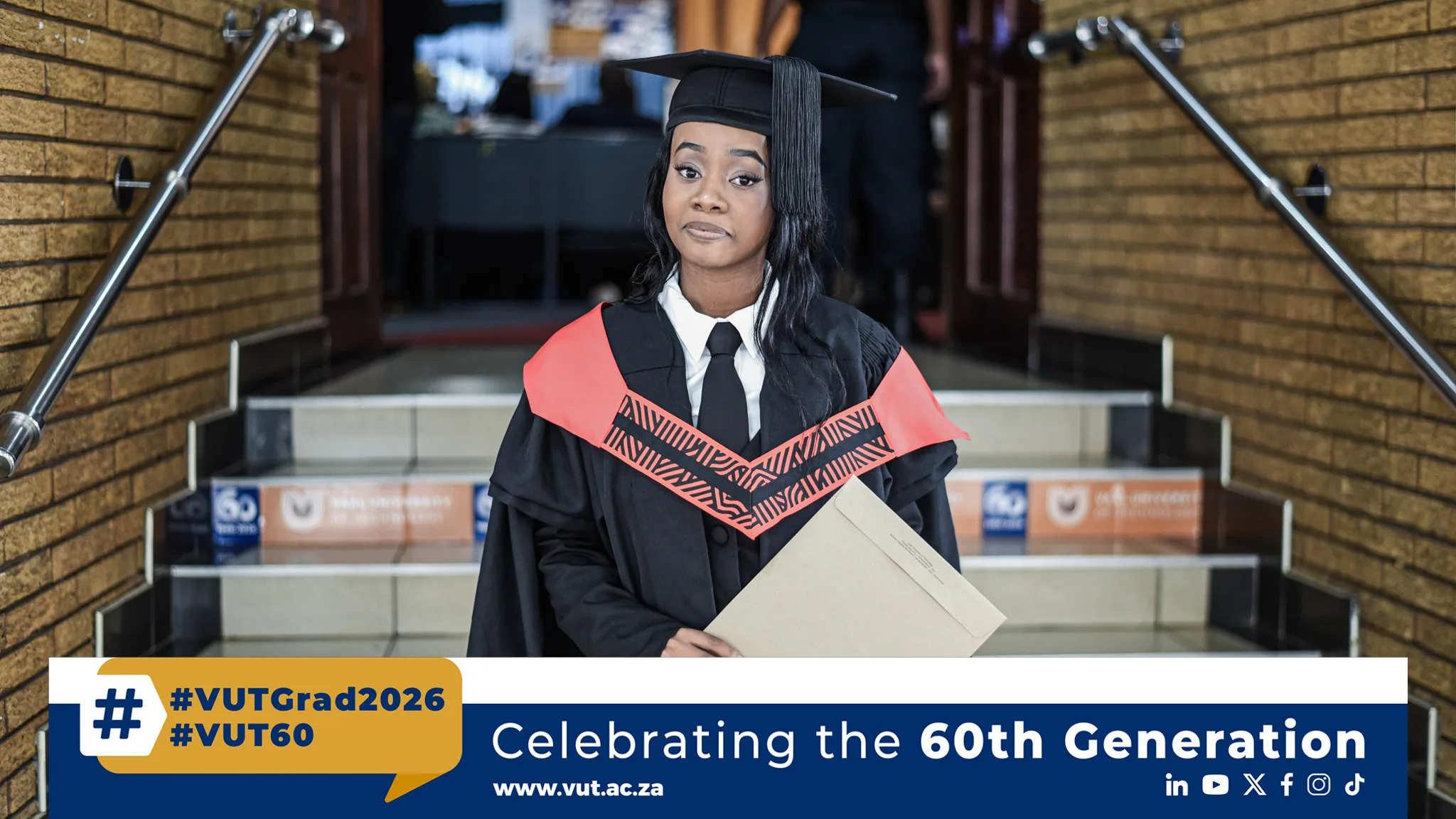 Goitsemang Marago – Vaal University of Technology Graduate in cap and gown posing on stairs with diploma during graduation celebration.