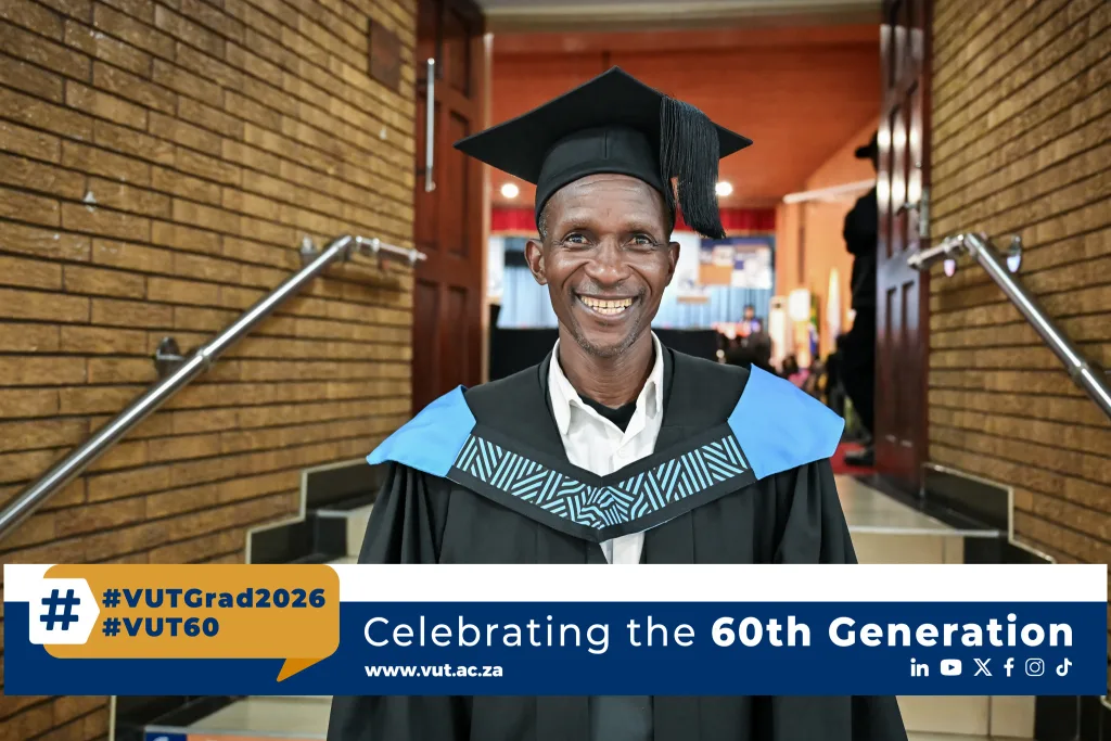 Mr Kwena Moabelo – Vaal University of Technology Graduate in cap and gown smiling in a hallway; banner reads 'Celebrating the 60th Generation.'