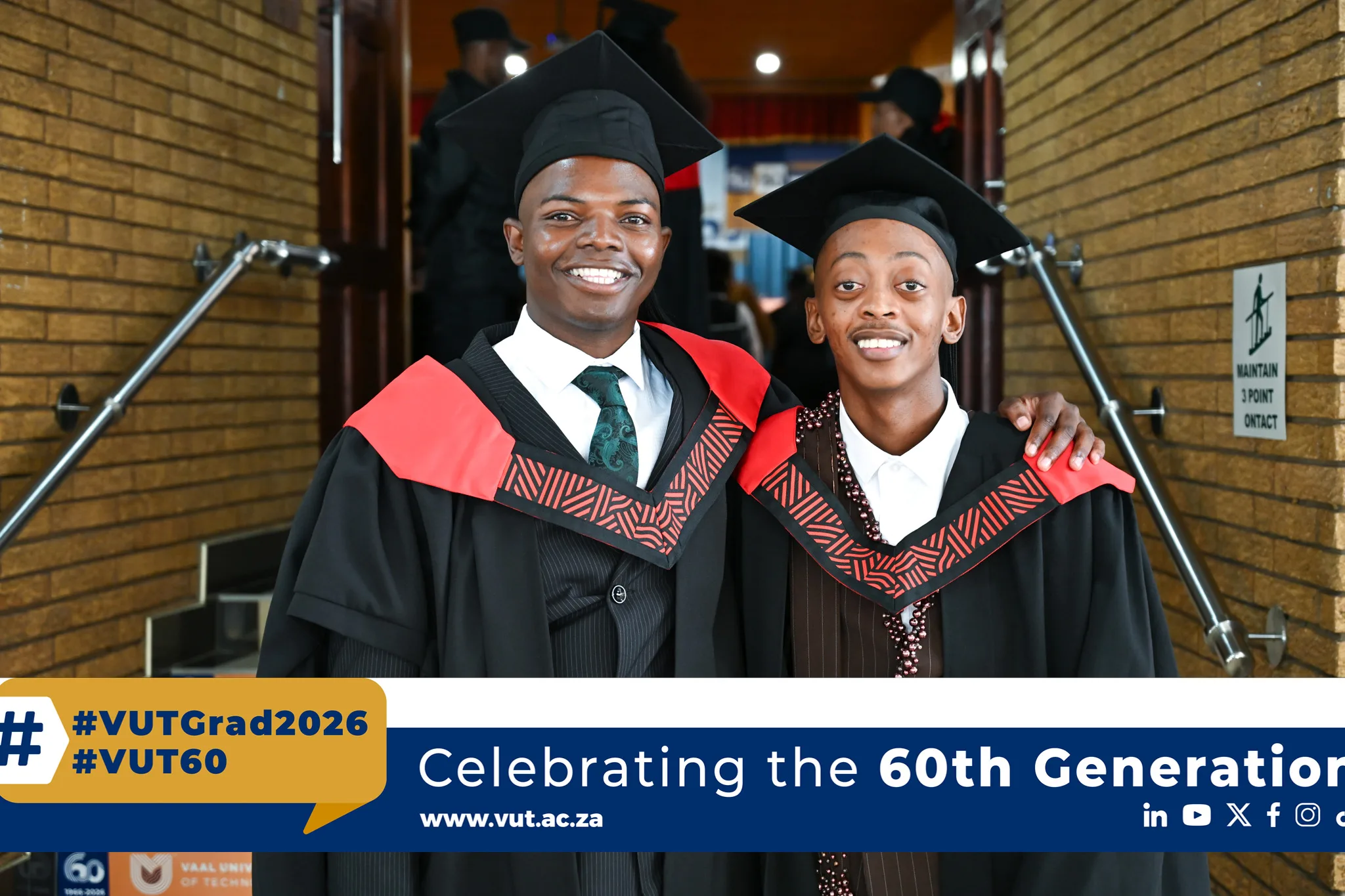 Wandile Tshepiso – Vaal University of Technology Two graduates in black gowns with red stoles smile and pose together at a graduation ceremony.
