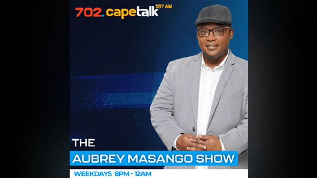 Promotional poster for The Aubrey Masango Show on 702 CapeTalk, featuring a man in a light gray blazer and cap against a blue background.