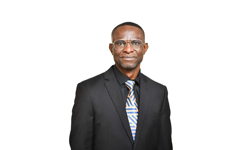 Head-and-shoulders portrait of a man in a black suit, orange-blue striped tie, and glasses, facing the camera.