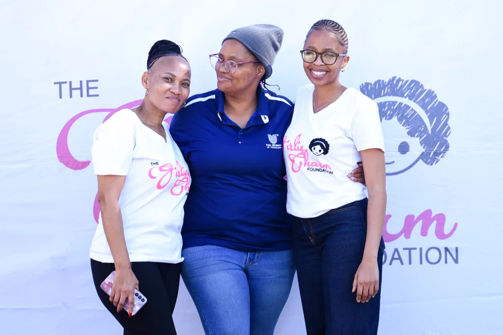 The Girlie Charm – Vaal University of Technology A VUT Community Engagement Department representative (centre) with Girlie Charm representatives.