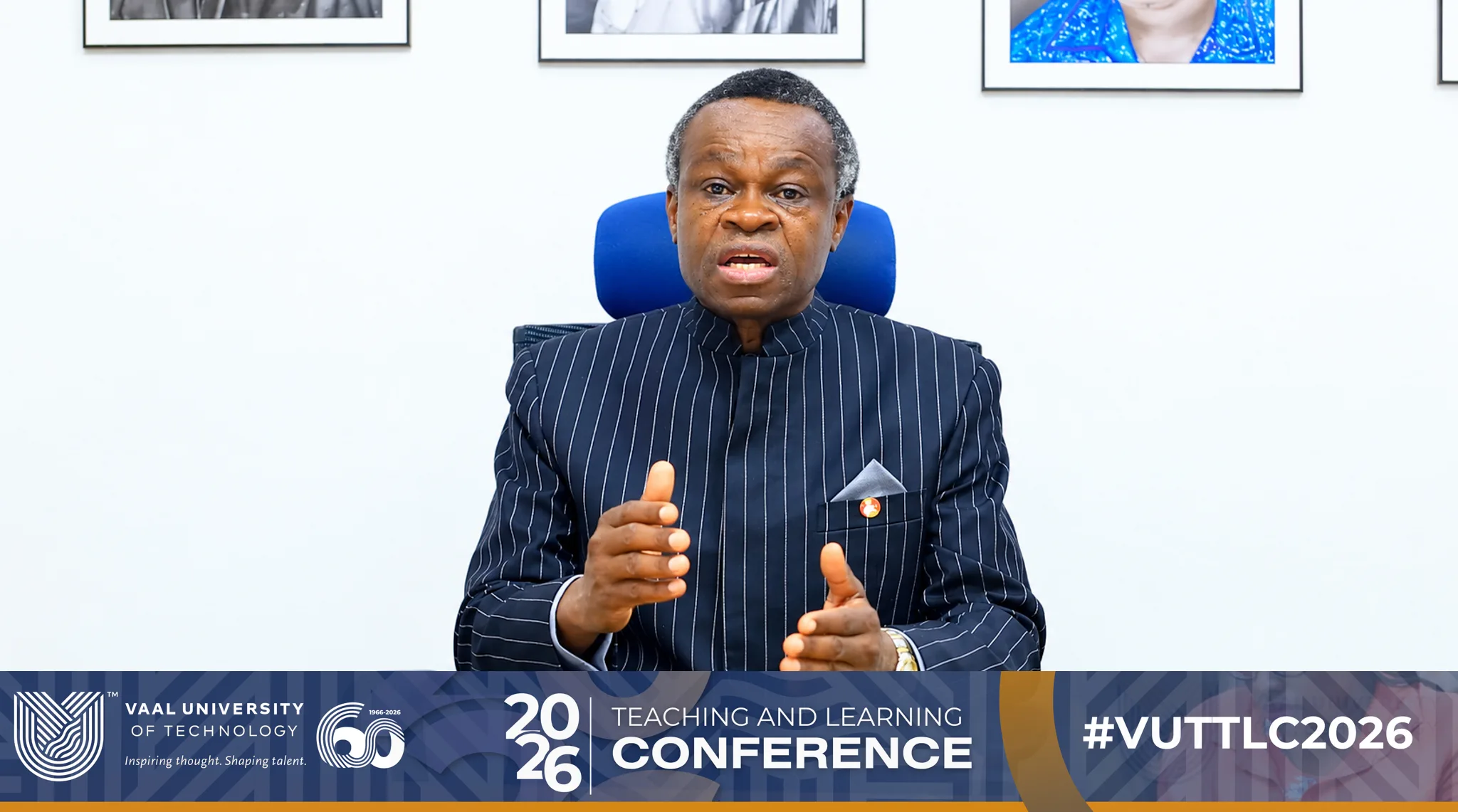 Man in a dark pinstriped suit speaks at a conference, with a Vaal University of Technology banner reading 'Teaching and Learning Conference 2026' at the bottom.
