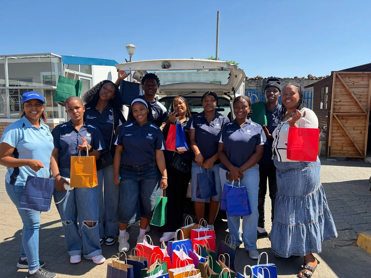 VUT second-year Public Relations students pictured with SANCA Vaal Triangle representatives during their community outreach visit on 17 October 2026, where they donated goodie bags containing toiletries and snacks to support residents on their recovery journeys.